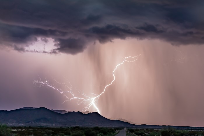 Lightning strike over desert mountains during a monsoon storm