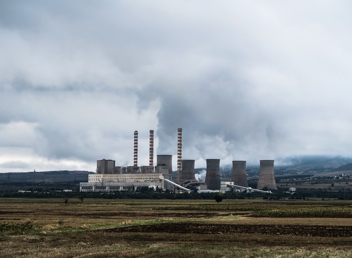 Power plant with cooling towers and smokestacks