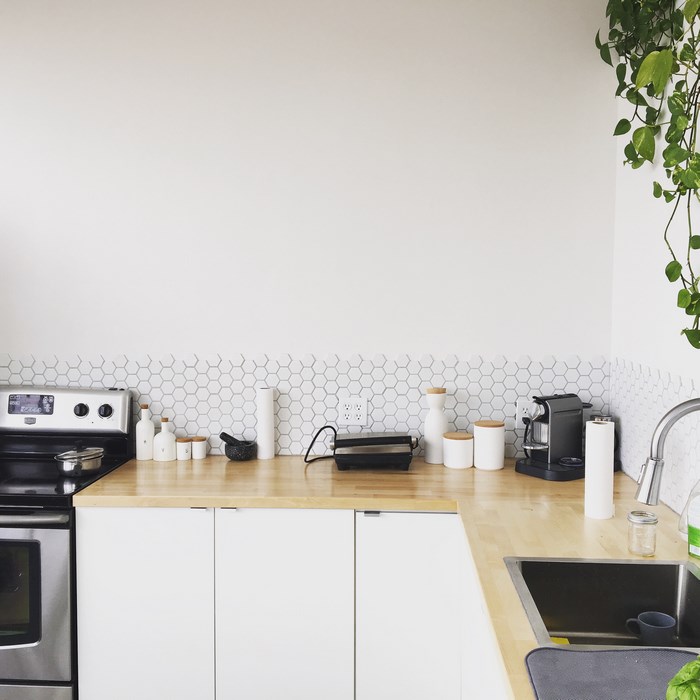 Kitchen counter with appliances and white hexagonal backsplash