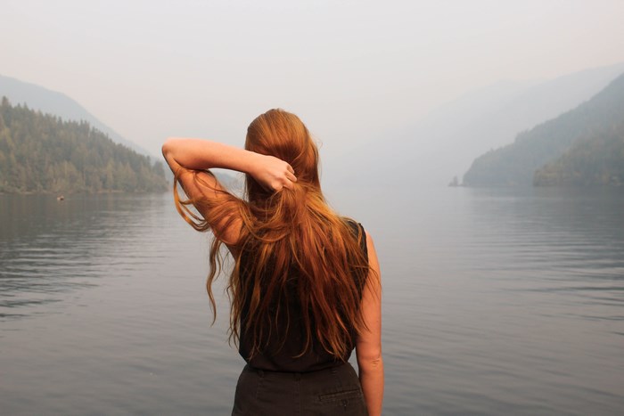 Woman with red hair by a lake