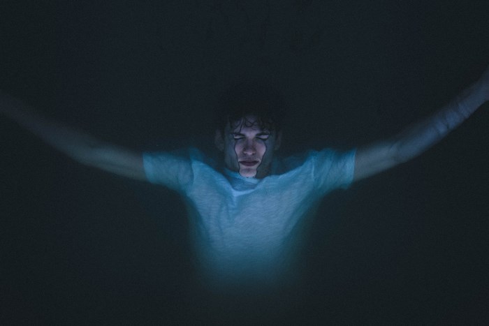 Man floating in dark water