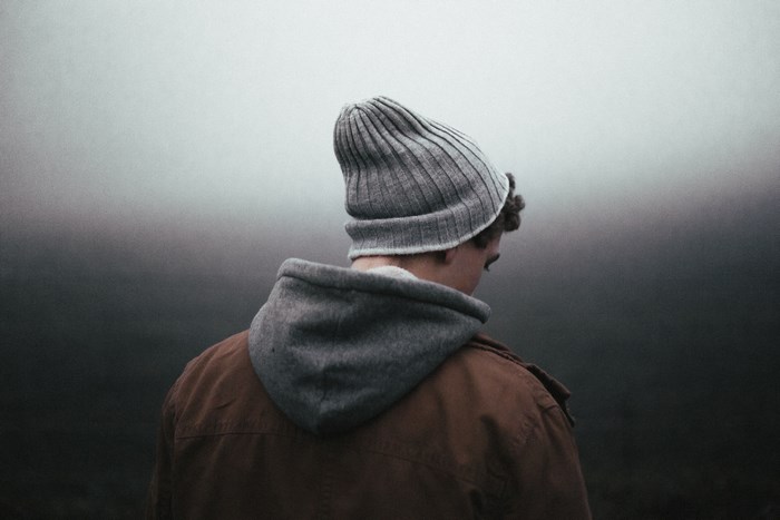 Man wearing a beanie and jacket in fog