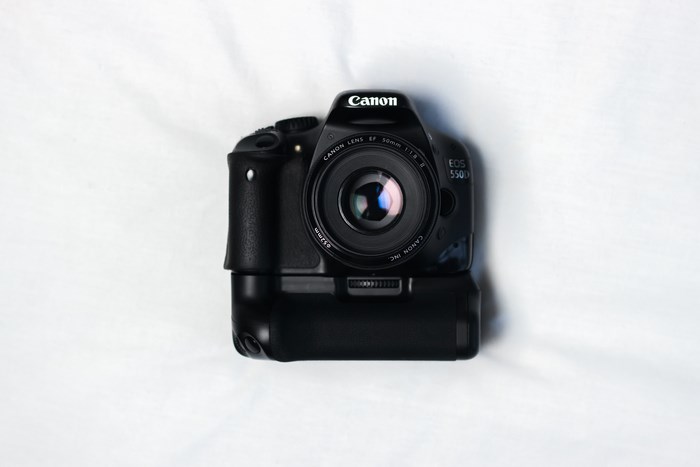 Canon EOS 550D DSLR camera with 50mm lens and battery grip