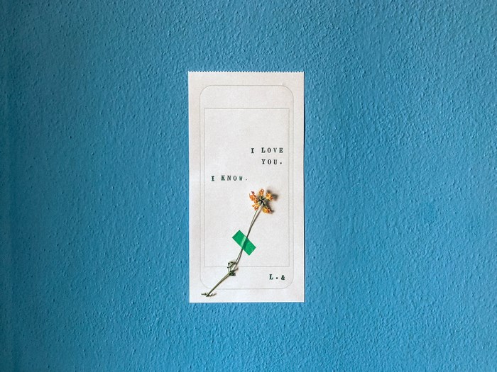 I Love You quote with dried flower on paper