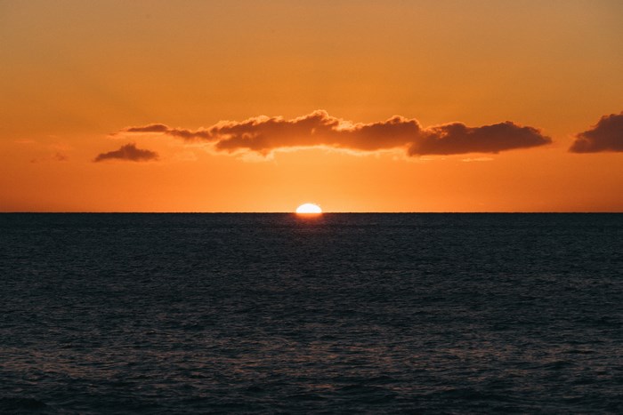 Sunset over the ocean with clouds