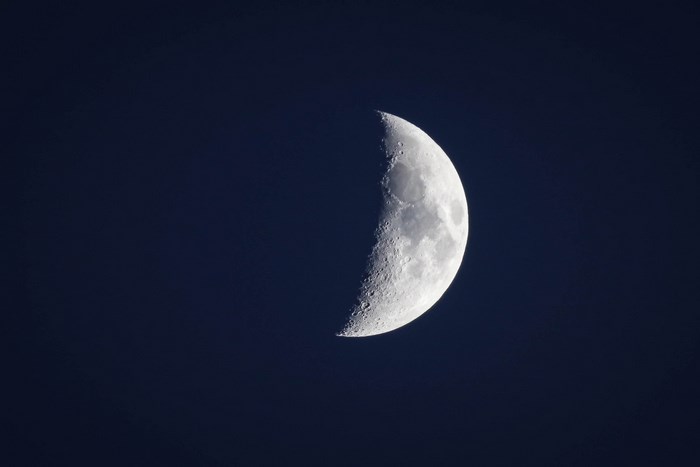 Half moon in dark night sky