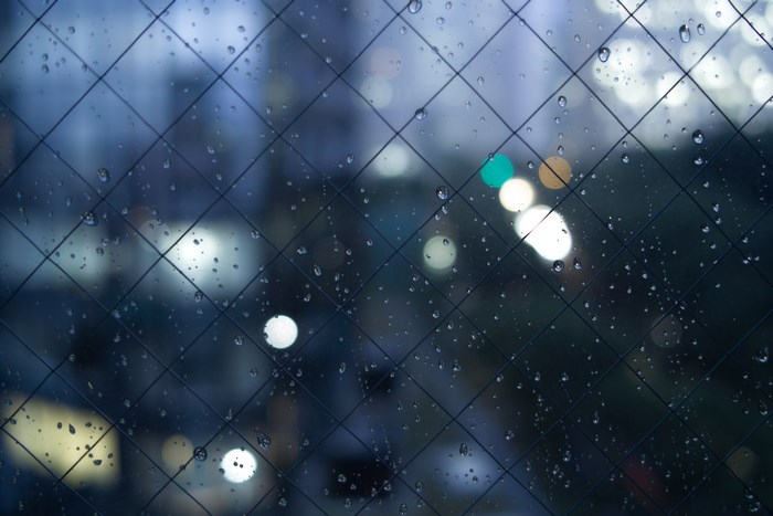 Rainy Night City Lights Through Wet Window