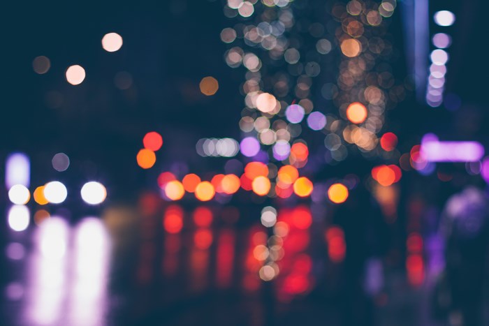 Blurred city lights at night with reflections