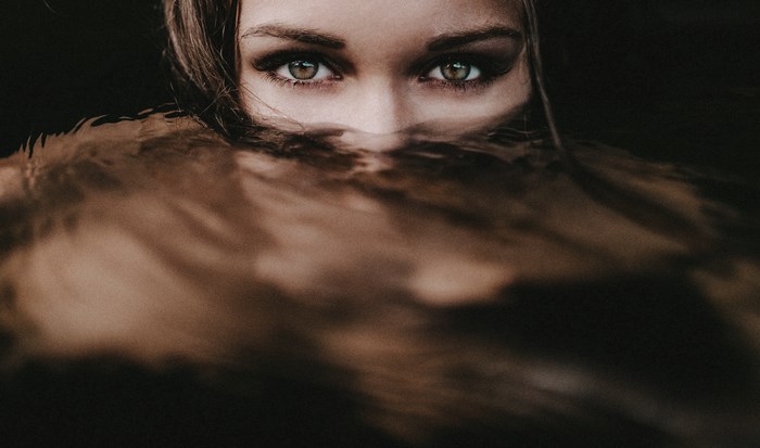 Woman's eyes peeking from underwater