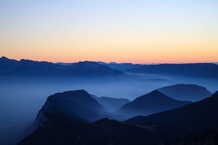 Misty Mountain Ridges at Dusk with Colorful Sky