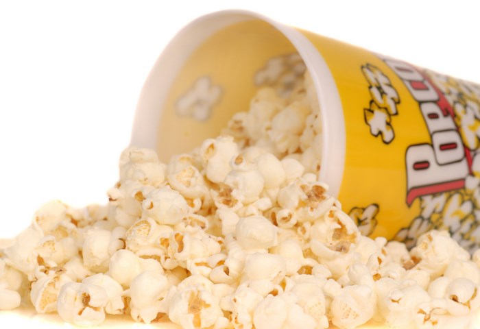Popcorn spilling from a yellow container