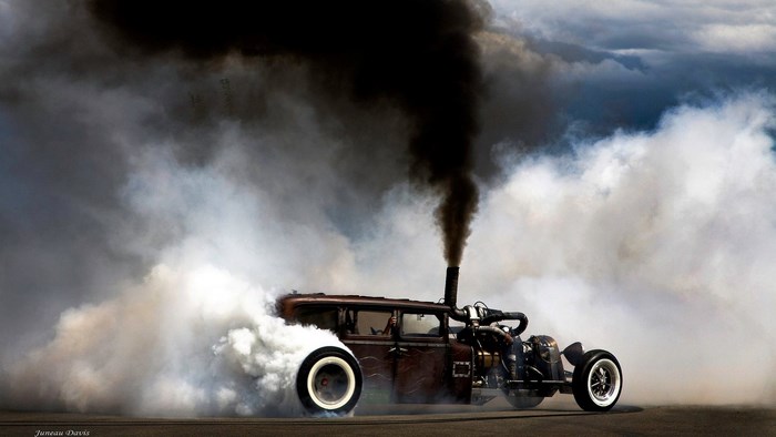 Rat Rod Car Performing a Burnout with Black Smoke