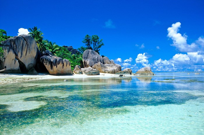 Tropical beach with granite boulders and clear turquoise water