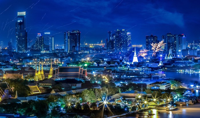 Bangkok skyline with fireworks over the Chao Phraya River at night