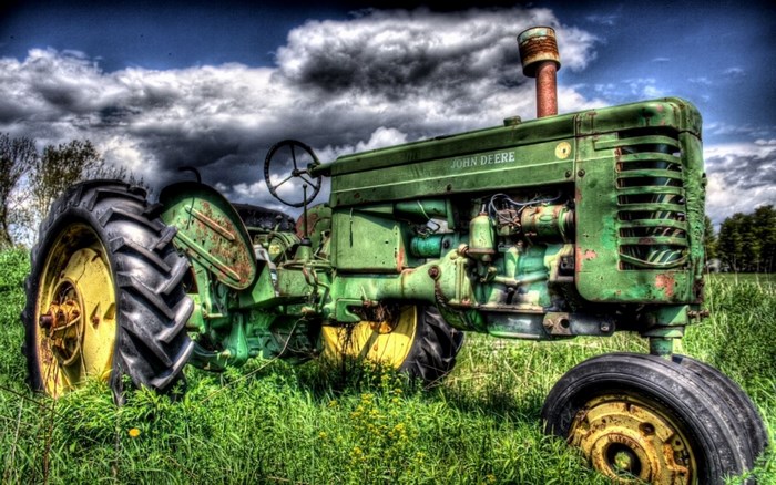 Green John Deere tractor in a field