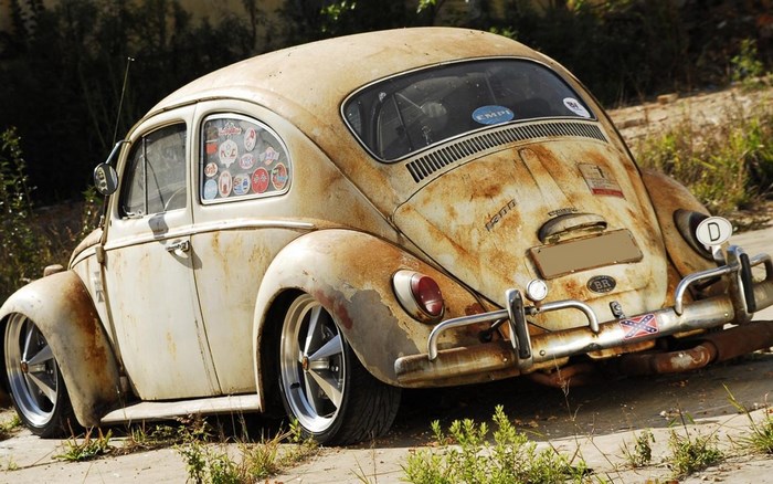 Rusty Volkswagen Beetle with custom wheels