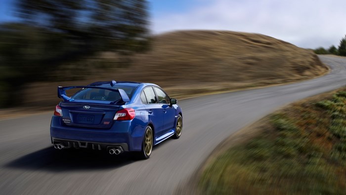 2015 Subaru WRX STI driving on a winding road