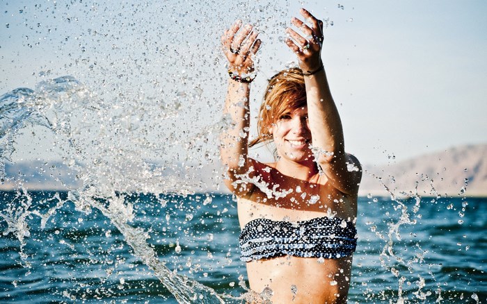 Woman splashing water in the ocean