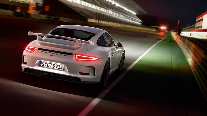 White Porsche 911 GT3 on a Race Track at Night