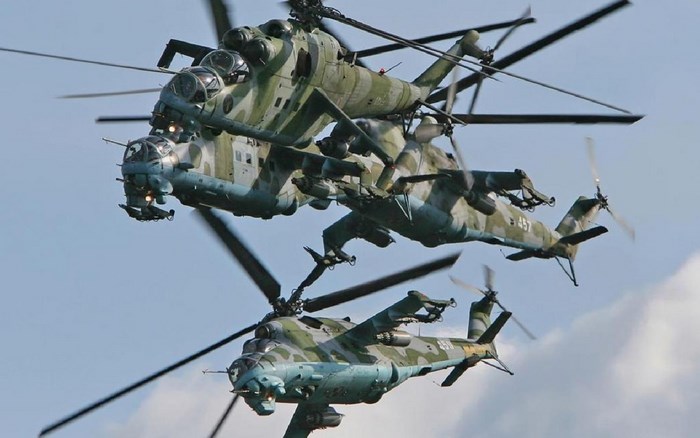 Three Mil Mi-24 helicopters in flight