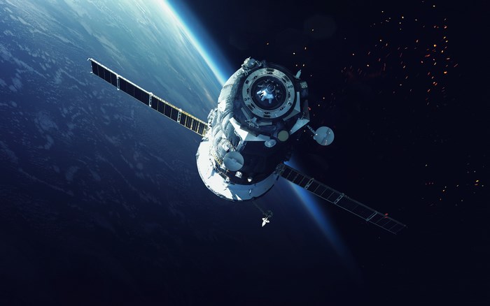 Satellite orbiting Earth with debris