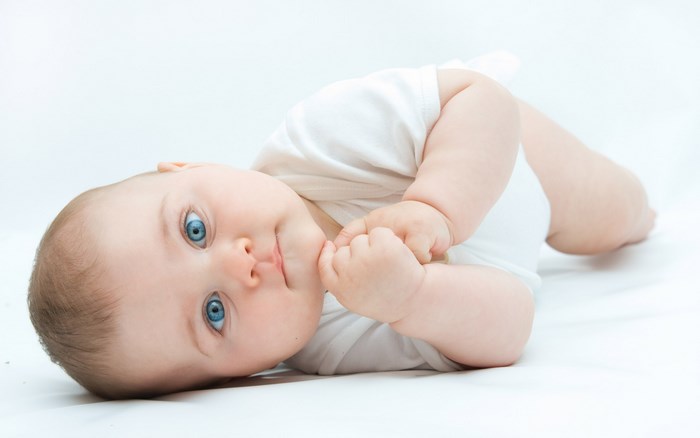 Baby lying on a white background