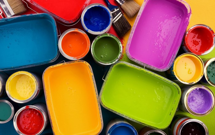 Assortment of colorful paint cans and brushes