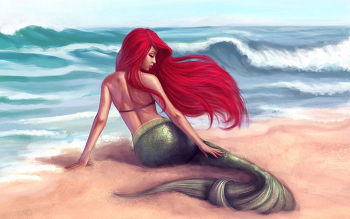 Ariel the mermaid sitting on a beach