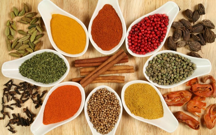Assorted Colorful Herbs and Spices on Wooden Surface