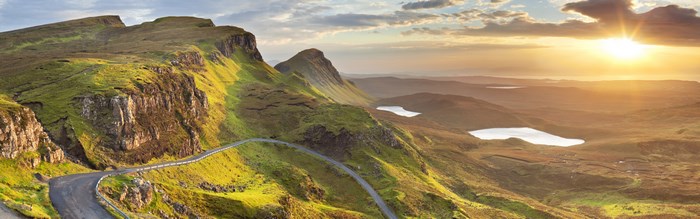 Mountain road with lakes at sunset