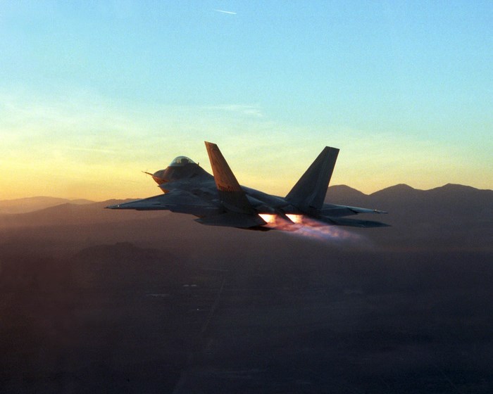 Lockheed Martin F-22 Raptor flying at sunset