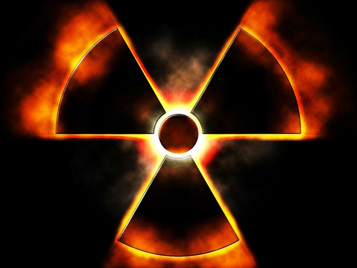 Radioactive symbol with fire and smoke