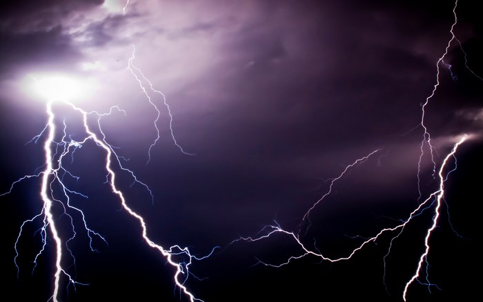 Lightning strikes in a dark, stormy sky