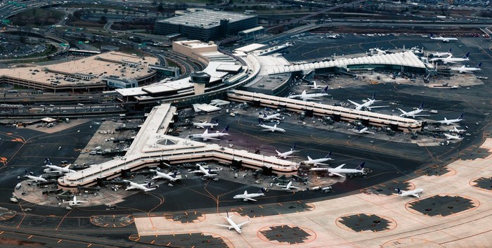 Aerial view of a busy airport with many airplanes