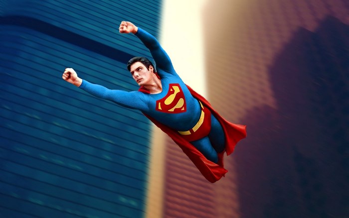 Superman flying in front of buildings