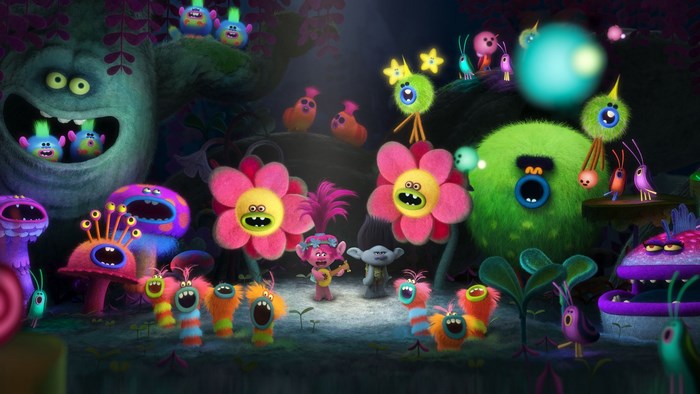 Trolls characters in a dark, glowing forest