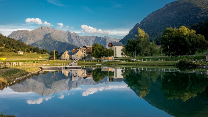 Mountain village with lake reflection