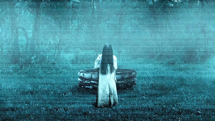 Samara from The Ring standing by a well