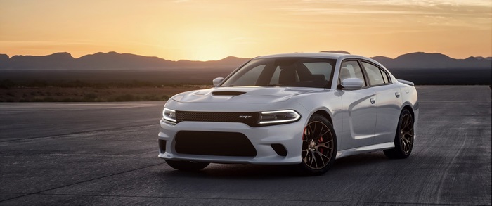 White Dodge Charger SRT on asphalt at sunset