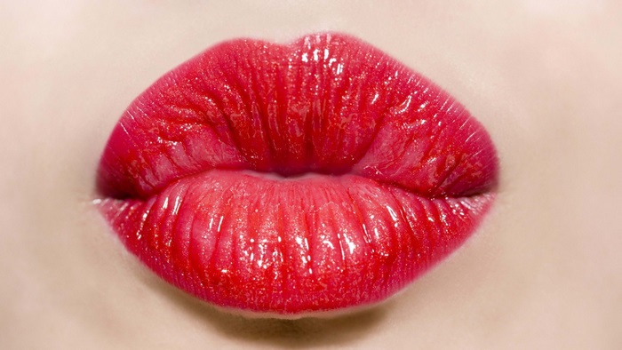 Close-up of red glossy lips