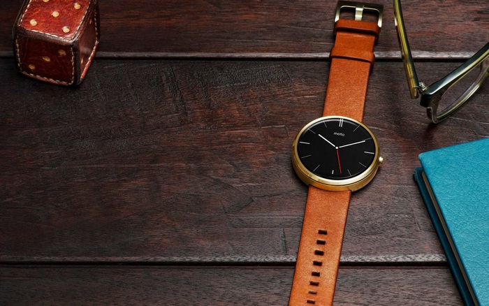 Motorola smartwatch with leather strap on wooden table