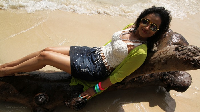Trisha on a beach with driftwood