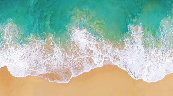 4K Aerial View of Turquoise Ocean Waves on Sandy Beach