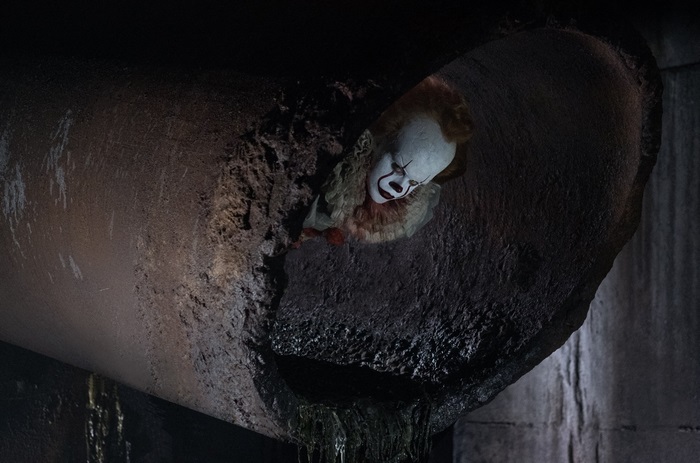 Pennywise the Clown from It in a sewer pipe