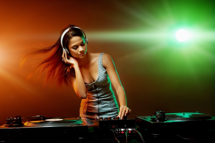 4K DJ Woman Mixing Music with Colorful Lights