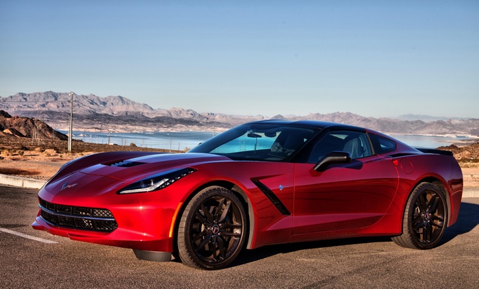 Red Chevrolet Corvette C7 parked by a lake