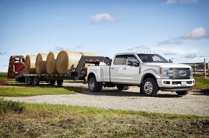 White Ford F-450 Truck Towing Hay Bales