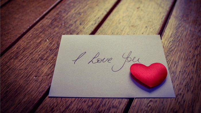 I Love You note with red heart on wood