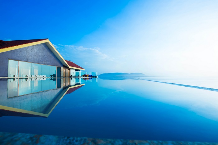 Infinity pool at a beach resort with a clear blue sky
