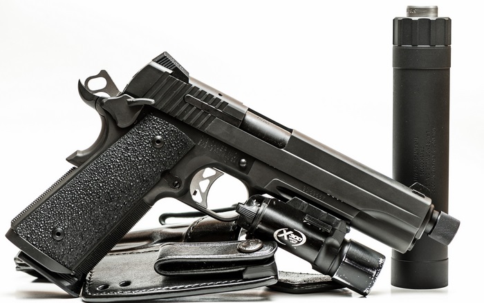 Sig Sauer P226 pistol with suppressor and light